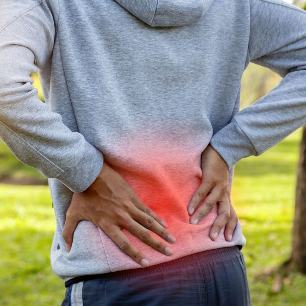 Guy holding his lower pain | Featured image for Our guide dealing with LBP.